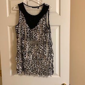 Notations medium sleeveless black and white top with vertical ruffles.